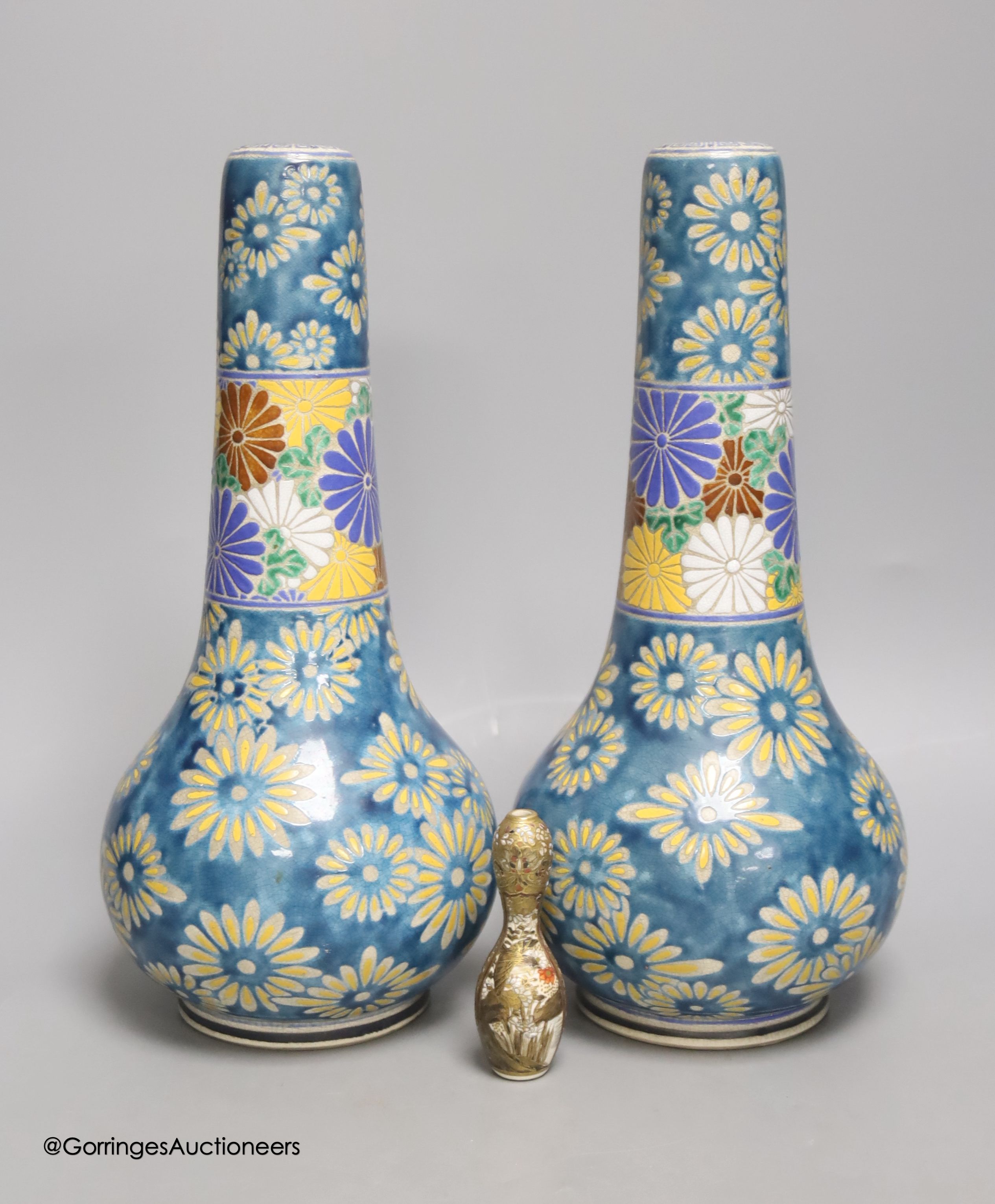 A pair of Japanese Satsuma pottery bottle vases by Taizan Yohei IX, 30cm and a miniature Satsuma vase